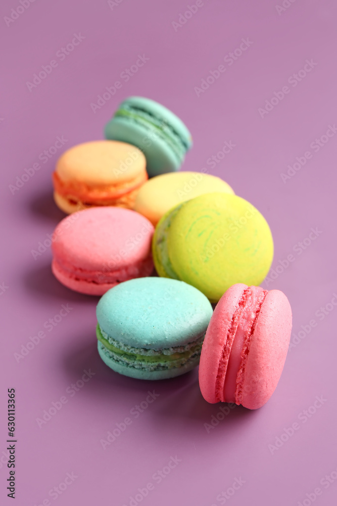 Different tasty sweet macaroons on purple background Different tasty sweet macaroons on purple background