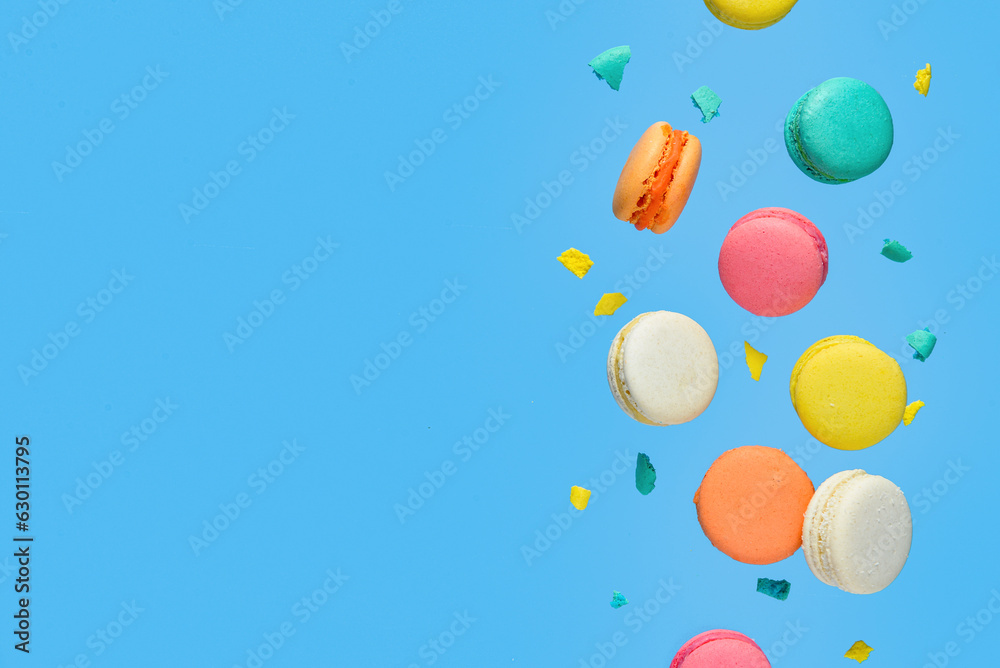 Flying sweet macaroons on blue background Flying sweet macaroons on blue background