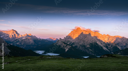 Beautiful panorama of mountains and green meadow in Dolomites, Italy. Beautiful and familiar mountain views illuminated by a beautiful morning or setting sun 