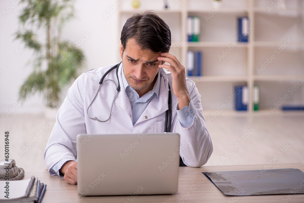 Young male doctor in telemedicine concept Young male doctor in telemedicine concept