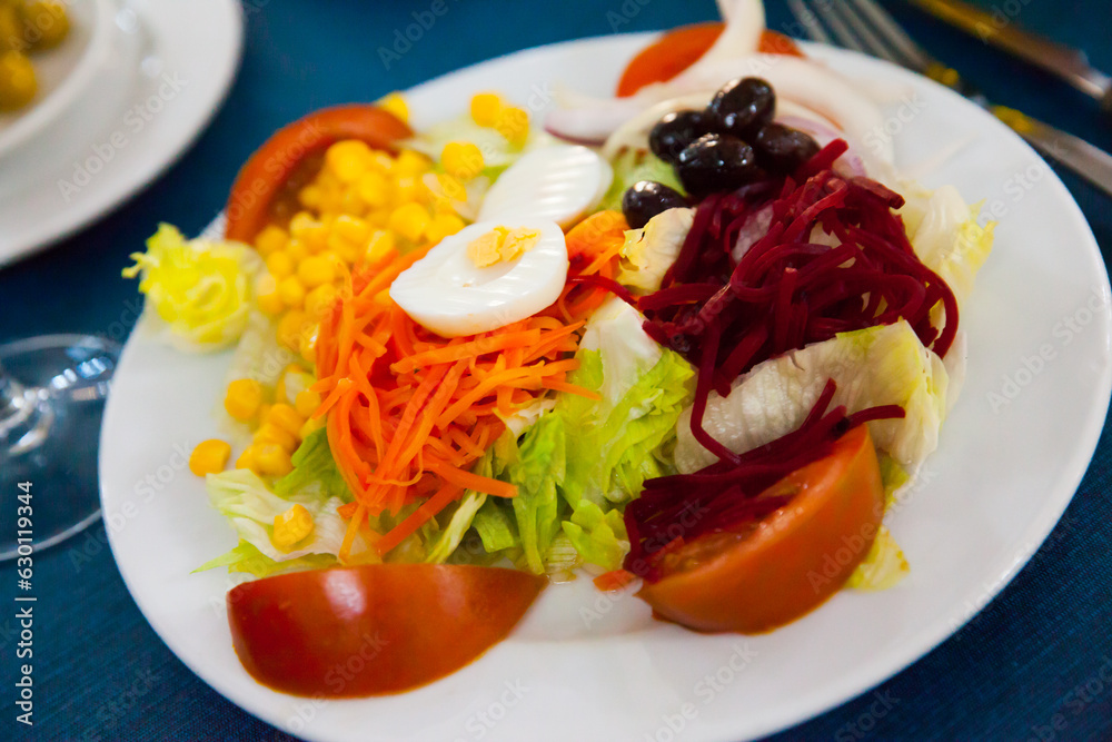 Mixed salad with eggs, fresh vegetables and boiled beet and carrot