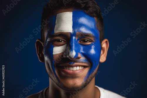 happy young man with a pattern on his face in the colors of the flag of El Salvador. 