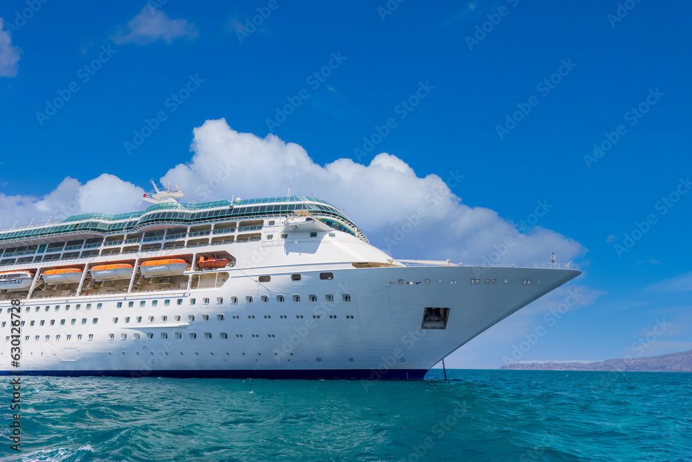 Greece Islands, cruise ship docked near Santorini island on a cruise vacation in Mediterranean.