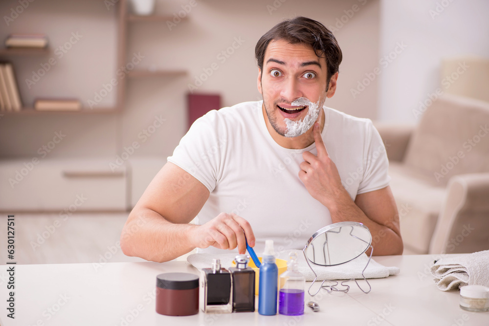 Young man shaving face at home Young man shaving face at home