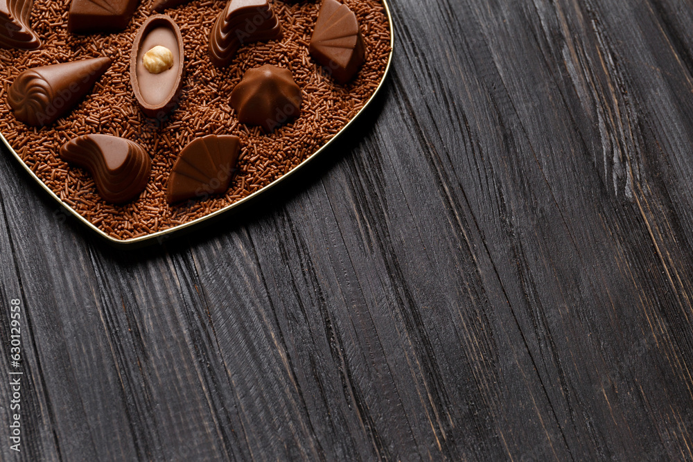 Candies with chocolate praline in chocolate chips on a dark wooden background, copy space. Candies with chocolate praline in chocolate chips on a dark wooden background, copy space.