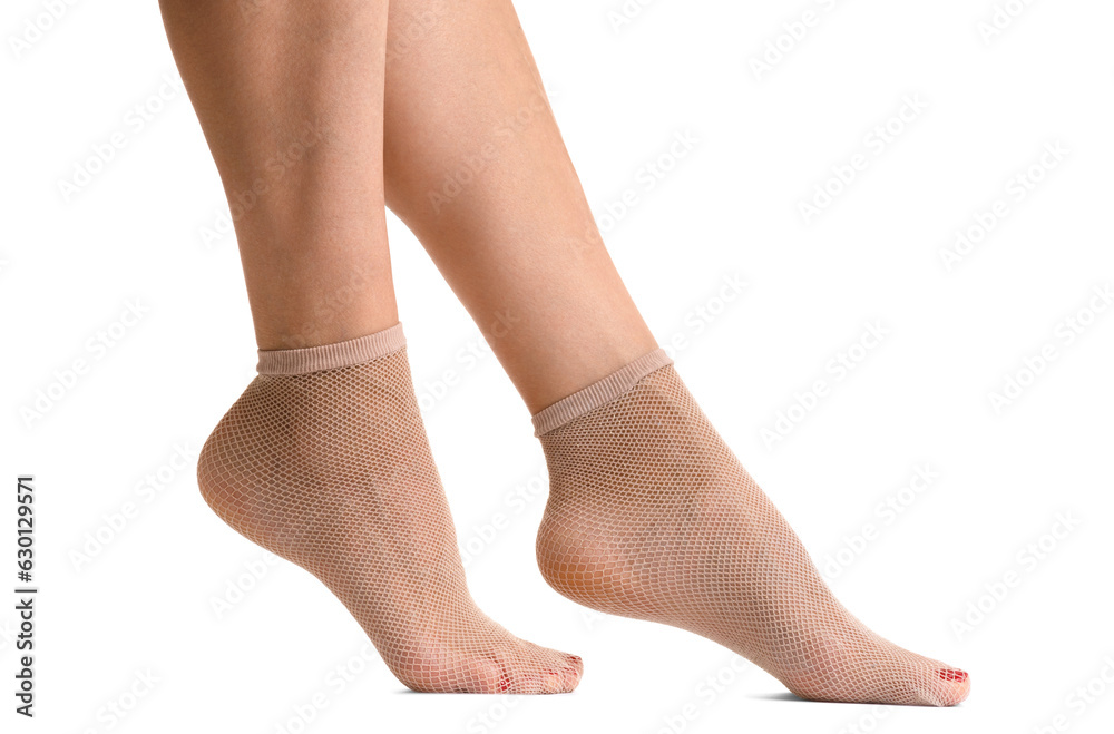Female legs in beige fishnet socks, isolated on white background. Female legs in beige fishnet socks, isolated on white background.