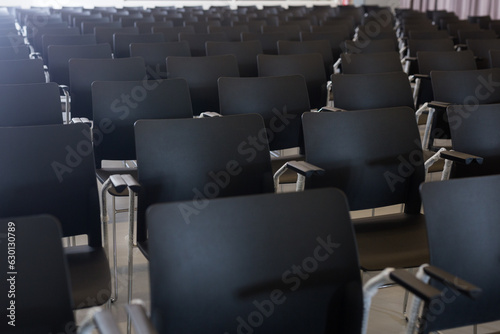 Close up of dark plastic chairs in conference room
