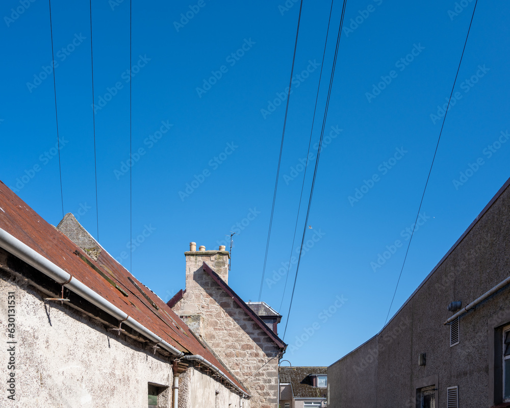 1 August 2023. Nairn,Scotland. This is multiple telephone lines in a lane in Nairn going to various houses on a very blue sky day 1 August 2023. Nairn,Scotland. This is multiple telephone lines in a lane in Nairn going to various houses on a very blue sky day