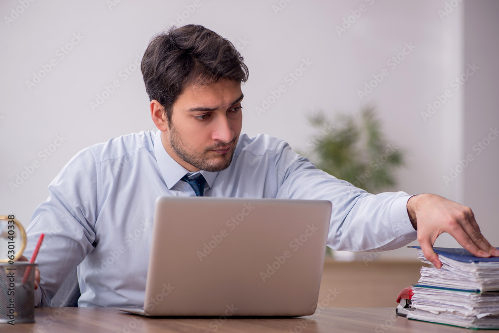 Young male employee working in the office Young male employee working in the office