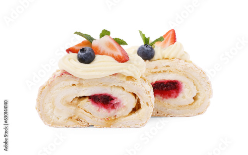 Slices of tasty meringue roll with jam, berries and mint leaves isolated on white