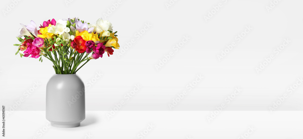 Vase with beautiful colorful freesias on white background, banner design