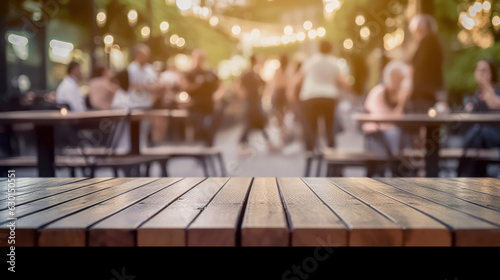 An outdoor table where people are watching some people blur background