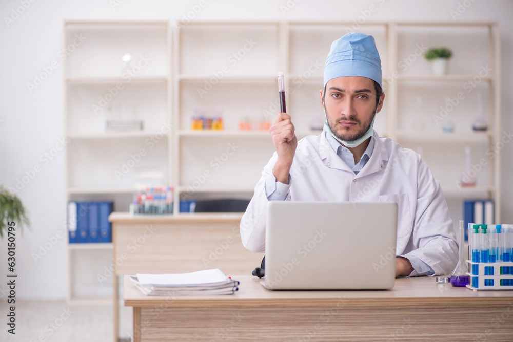 Young male chemist working at the lab Young male chemist working at the lab