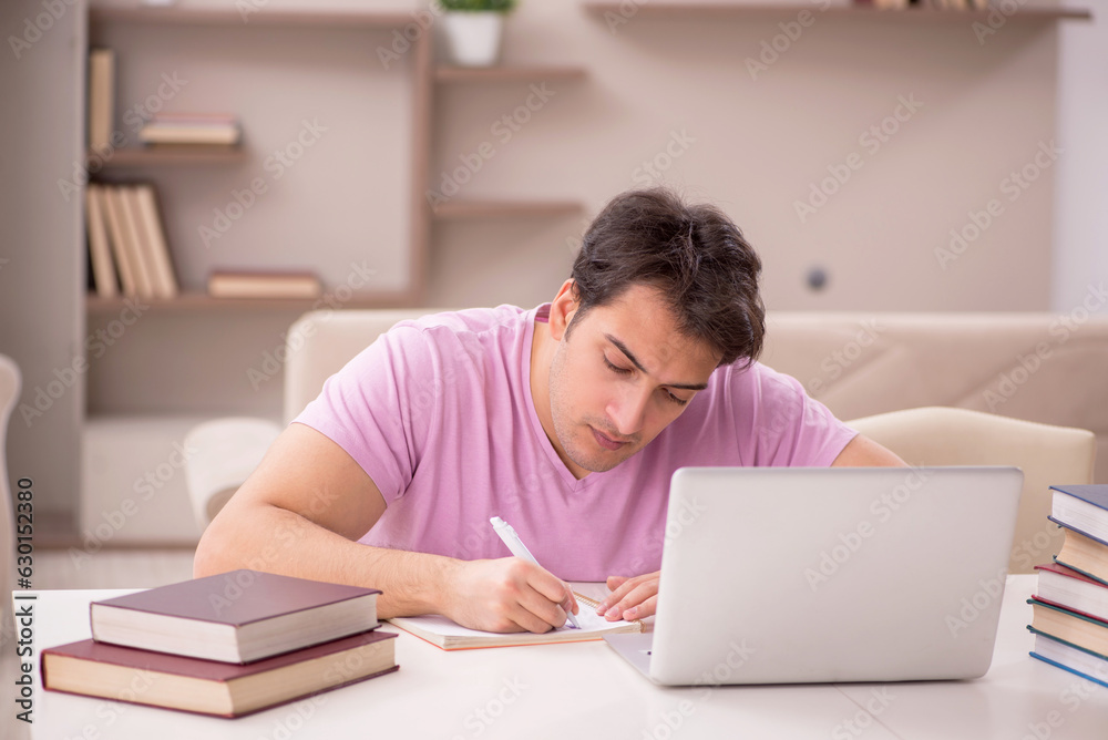 Young male student preparing for exams at home Young male student preparing for exams at home