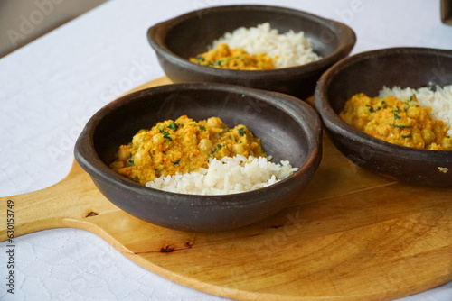 Close up view of 3 ceramic bowls with chickpeas curry with rice. An excellent alternative for healthy cooking-