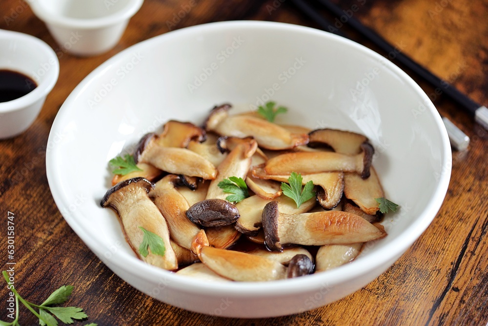 Fried sliced king oyster mushrooms in soy sauce Fried sliced king oyster mushrooms in soy sauce