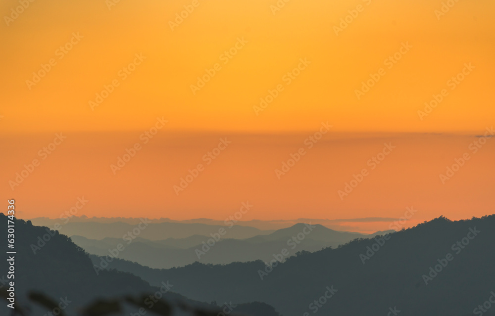 Fototapeta premium Scenic view dramatic beautiful sunset sky. Natural Sunset Sunrise on meadow silhouette shadow dark land. Vibrant dramatic sky on sunset, dawn, sunrise in Countryside. Landscape Colorful Sky At Sunset