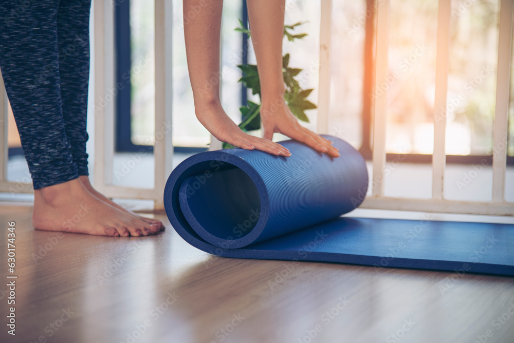 Woman Hands Rolled Up Yoga Mat On Gym Floor In Yoga Fitness Training