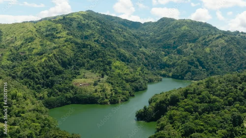 A beautiful lake among the mountains with tropical vegetation. Lake Balanan. Negros, Philippines A beautiful lake among the mountains with tropical vegetation. Lake Balanan. Negros, Philippines
