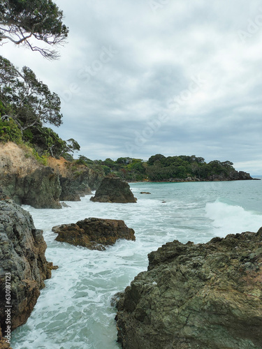 Morning with cloudy weather and rather big waves at Lang's beach in Whangarei districk, New Zealand.