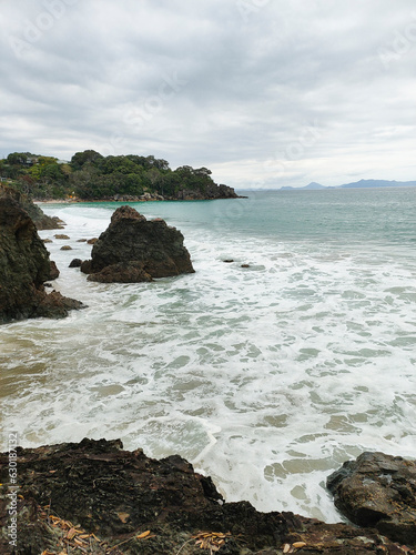 Morning with cloudy weather and rather big waves at Lang's beach in Whangarei districk, New Zealand.