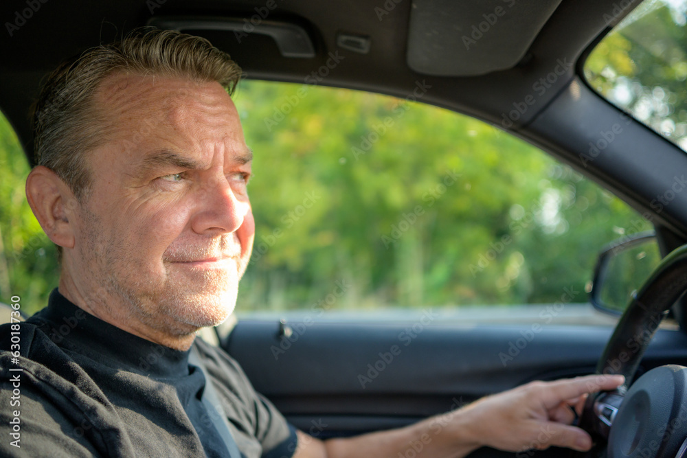 Man driving and looking critical Man driving and looking critical