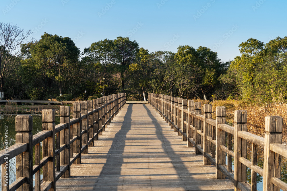 Wooden bridge over little river in city park