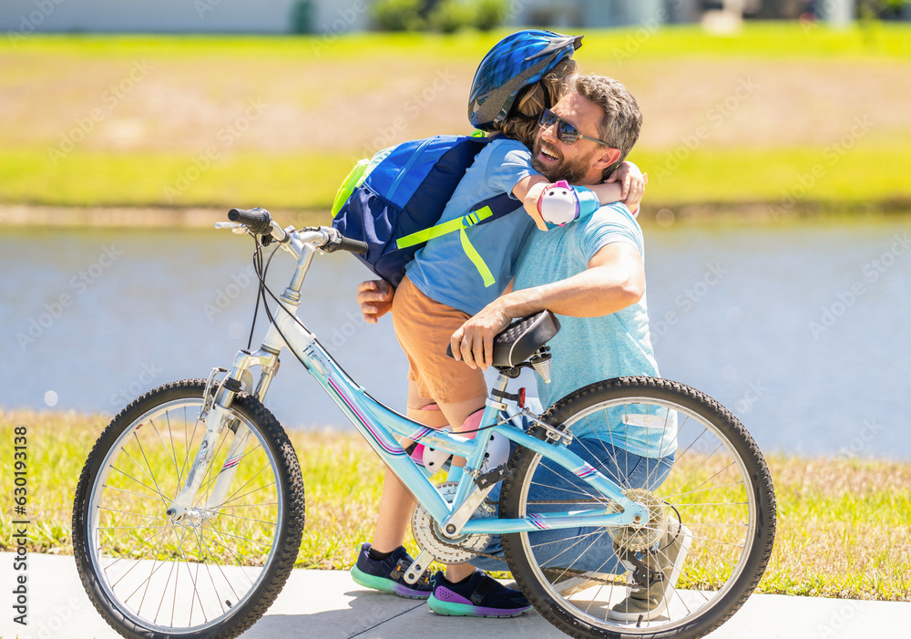 daddy and son kid outdoor. daddy and son spend time together. Creating cherished family memories. happy son and daddy cycling on bicycle. daddy teaching his son child to ride a bicycle