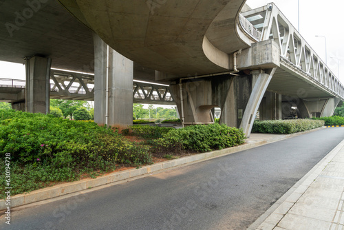 Concrete structure and asphalt road space under the overpass in the city