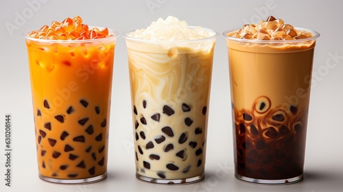 On a white background, iced milk tea and bubble boba are served in a plastic glass.. photo