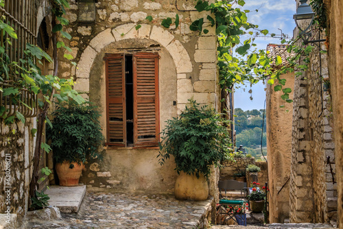 Fototapeta Naklejka Na Ścianę i Meble -  Traditional old stone houses on a street in the medieval town of Saint Paul de Vence, French Riviera, South of France