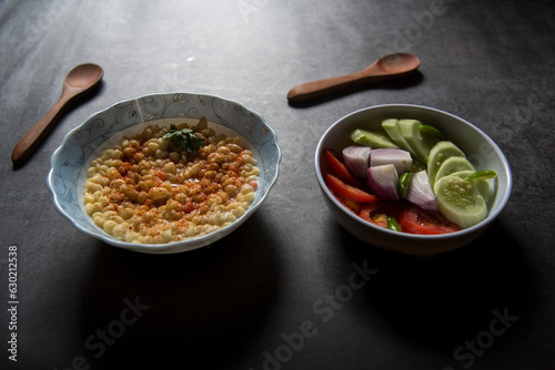 Rajasthani food ingredient bundi raita with yogurt and green salad. photo