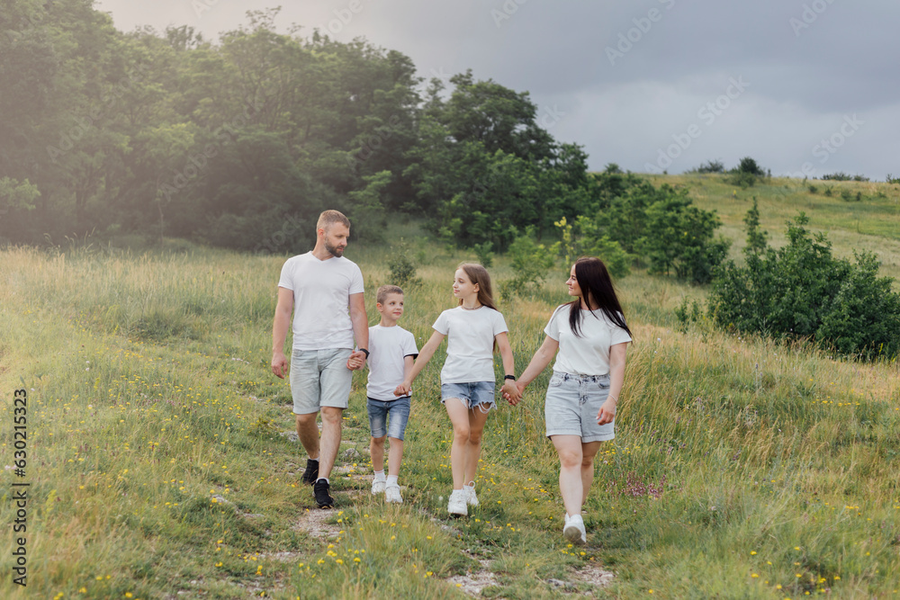 A happy family. Family on the background of the sky. Dad, mom and children.. Family Day. Happy and smiling children A happy family. Family on the background of the sky. Dad, mom and children.. Family Day. Happy and smiling children