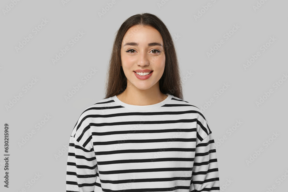 Portrait of beautiful young woman on light grey background Portrait of beautiful young woman on light grey background