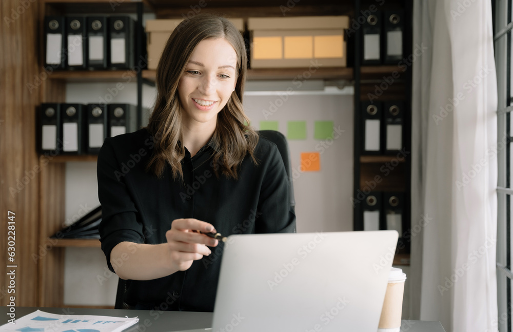 Business woman working at home office with laptop and documents on his desk, financial adviser analyzing data. Business woman working at home office with laptop and documents on his desk, financial adviser analyzing data.
