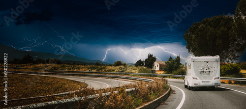 Obraz na płótnie White Caravan Motorhome Car Goes On Highway Road. bad weather, dangerous, thunderstorm, flash, lightning, thunderlight w salonie