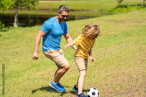 football family team of father and son. soccer activity. Fatherhood in outdoor of daddy and son kid. daddy with son improve fatherhood. Outdoor adventures of daddy and son fatherhood together