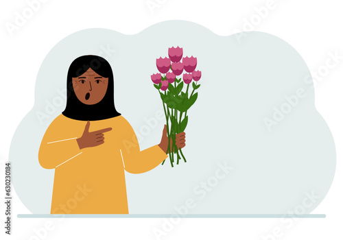 A arab woman is holding a large bouquet of flowers. The concept of a holiday, congratulations, romance or gift.