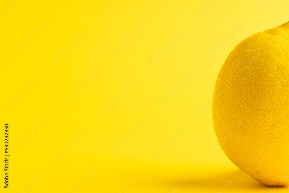 Close up of lemon and copy space on yellow background Close up of lemon and copy space on yellow background