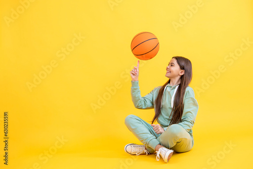 Teen girl excelling in basketball. Skilled teen girl playing the basketball. Competitive teen girl playing basketball. teen girl practicing basketball skills. copy space advertisement photo