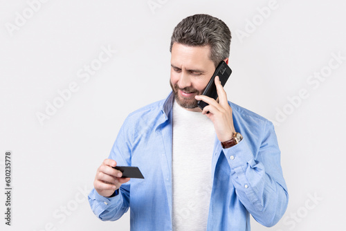 happy man contact by call card isolated on studio background. man contact by call card