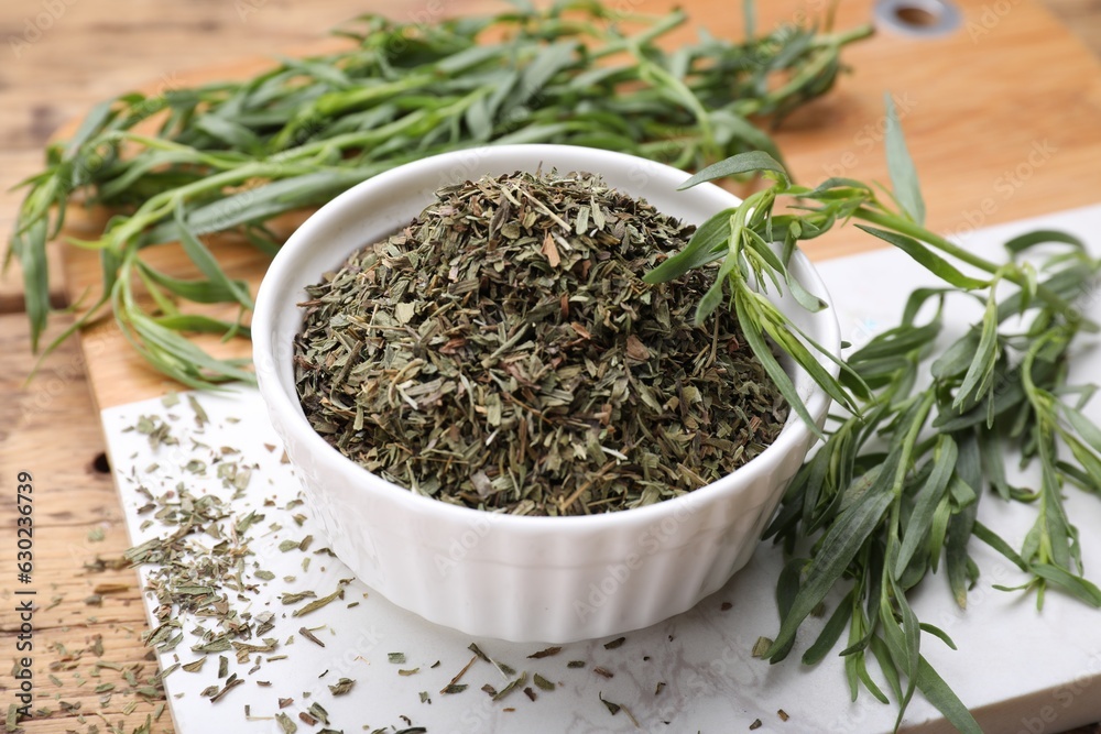 Dry and fresh tarragon on table, closeup Dry and fresh tarragon on table, closeup