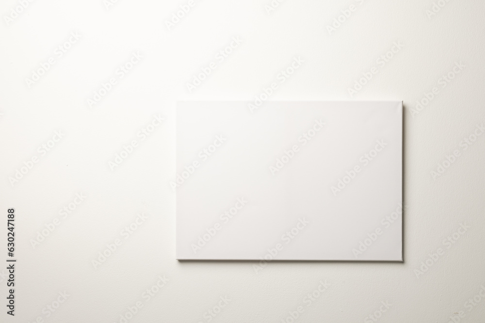 White canvas and copy space hanging in white wall background White canvas and copy space hanging in white wall background