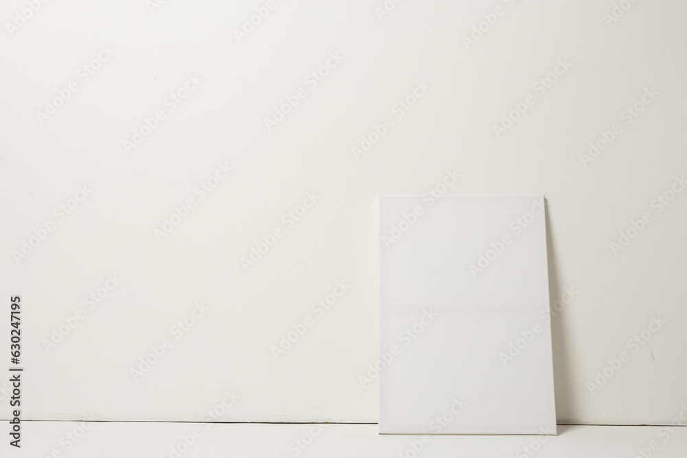 Fototapeta premium White canvas and copy space leaning against white wall background