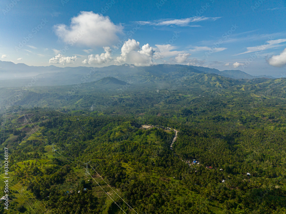 Obraz premium Mountain landscape: Mountain slopes covered with rainforest and jungle View from above. Mindanao. Philippines.
