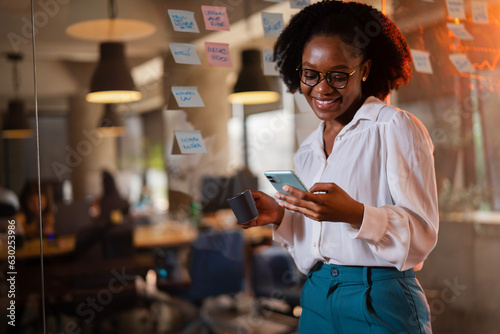 Happy businesswoman in office. Portrait of beautiful businesswoman using the phone.