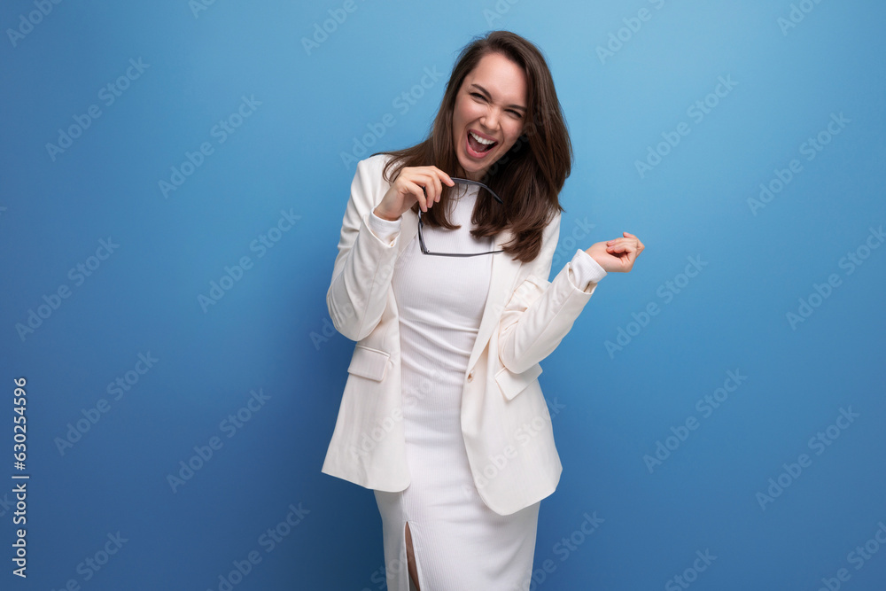 energetic young lady in a white dress and glasses demonstrates with her hands to the sides energetic young lady in a white dress and glasses demonstrates with her hands to the sides