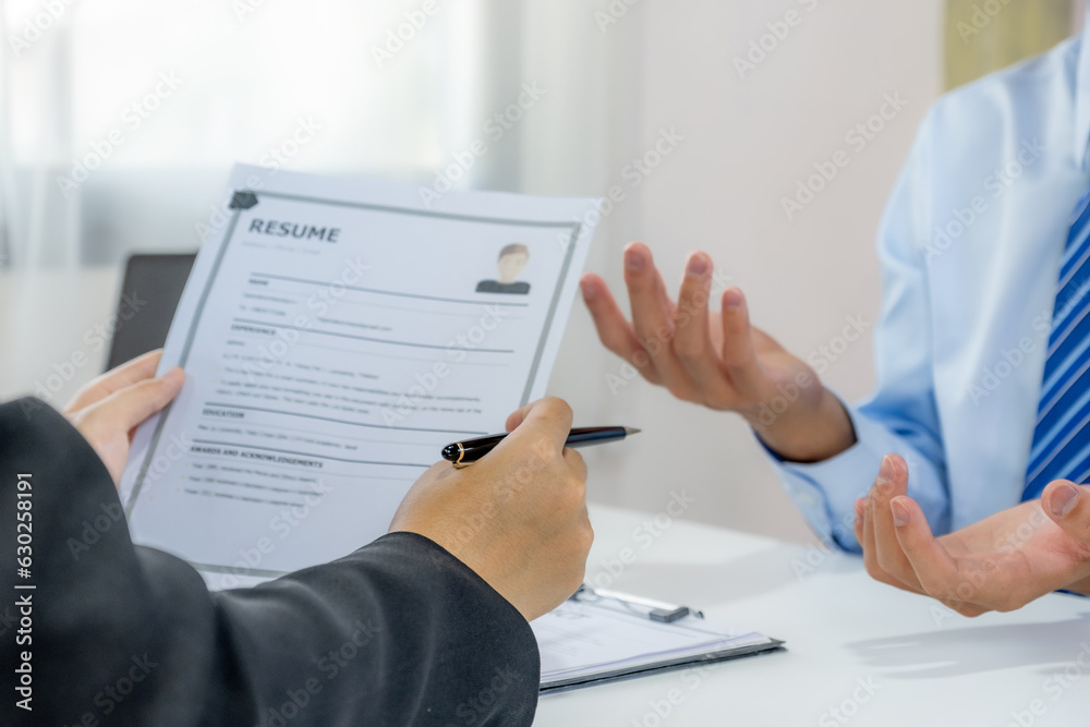 Office executives hand holding pen and interviewing job applicants in the meeting room. employer conversation summary work employment Office executives hand holding pen and interviewing job applicants in the meeting room. employer conversation summary work employment