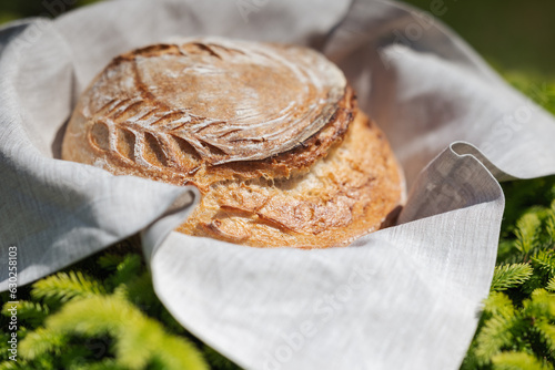 Φωτογραφία Close up of fresh wheat homemade bread on grey towel outdoors