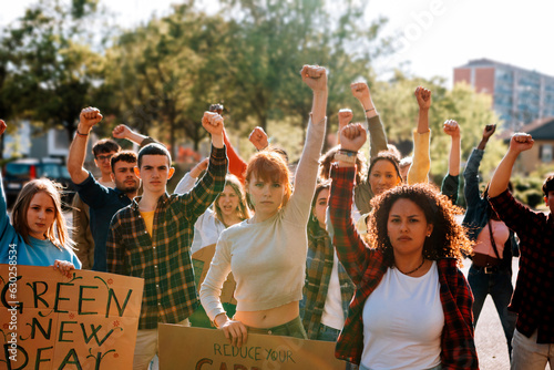 Canvastavla young crowd in protest demonstration - group of activists in march with raised f
